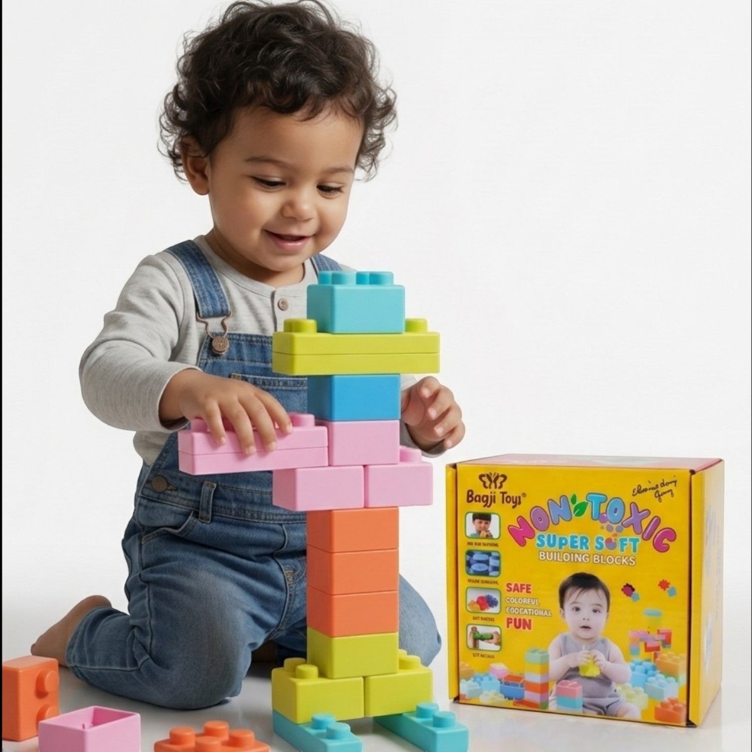 Toddler playing with BagjiToys soft, colorful, non-toxic educational building blocks on a white background.
